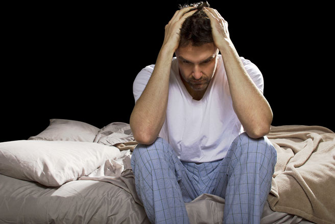 Frustrated man trying to get some sleep